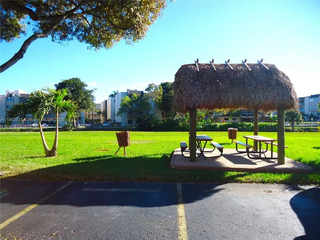 a view of a backyard with swimming pool