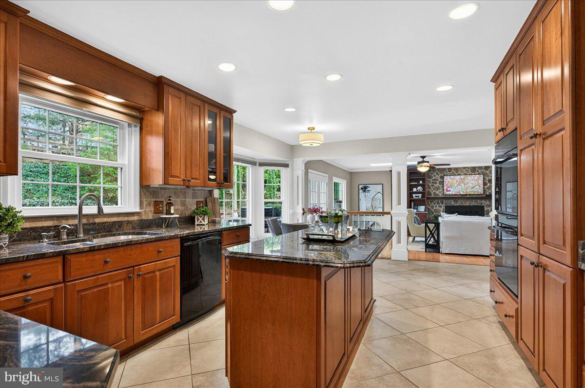 7723 Silver Sage Court Springfield, VA 22153 - Photo 11 of 63 a kitchen with kitchen island granite countertop a sink counter top space appliances and a counter top space