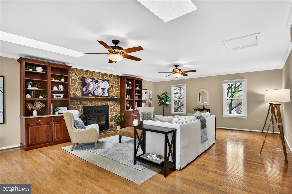 7723 Silver Sage Court Springfield, VA 22153 - Photo 15 of 63 a living room with furniture a fireplace and a flat screen tv