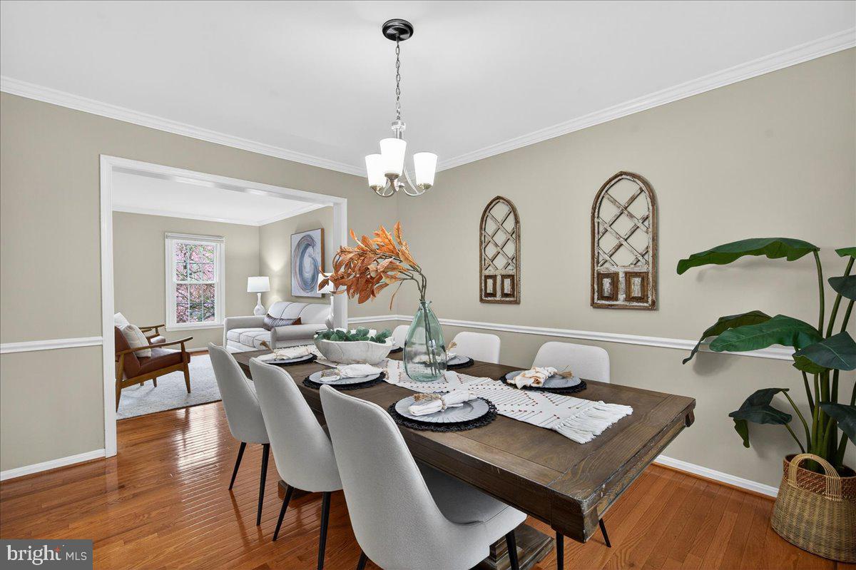 7723 Silver Sage Court Springfield, VA 22153 - Photo 28 of 63 a view of a dining room with furniture wooden floor and chandelier
