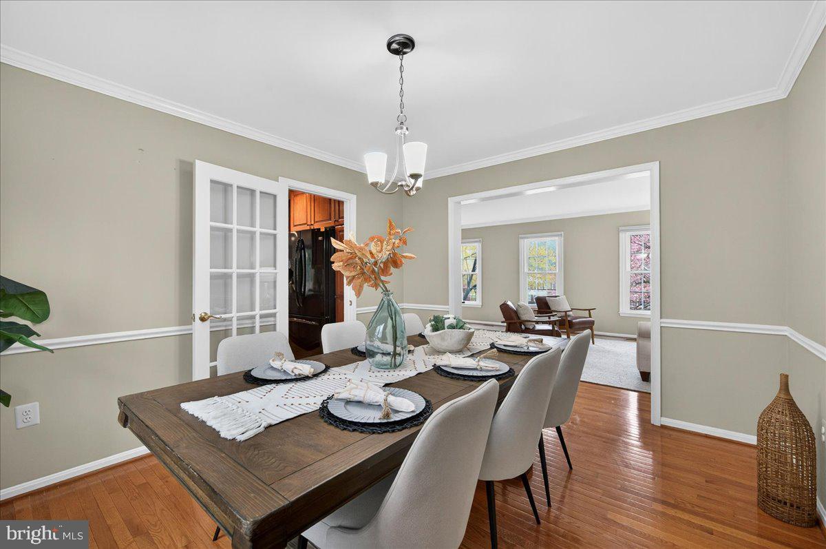 7723 Silver Sage Court Springfield, VA 22153 - Photo 29 of 63 a view of a dining room with furniture wooden floor and chandelier