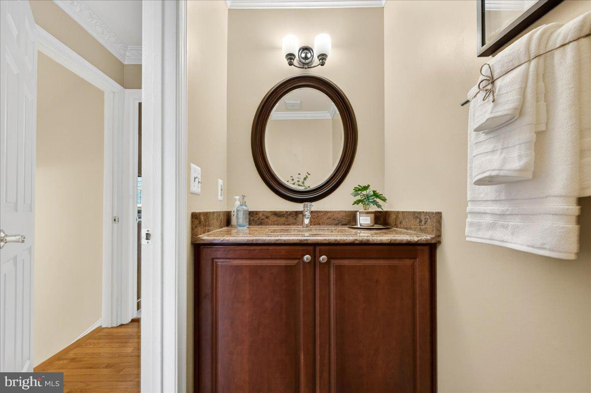 7723 Silver Sage Court Springfield, VA 22153 - Photo 30 of 63 a bathroom with a granite countertop sink and a mirror