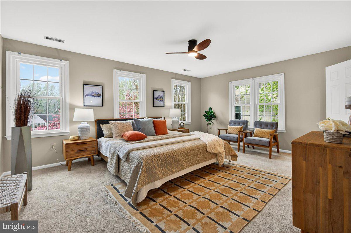 7723 Silver Sage Court Springfield, VA 22153 - Photo 32 of 63 a bedroom with a bed and wooden floor