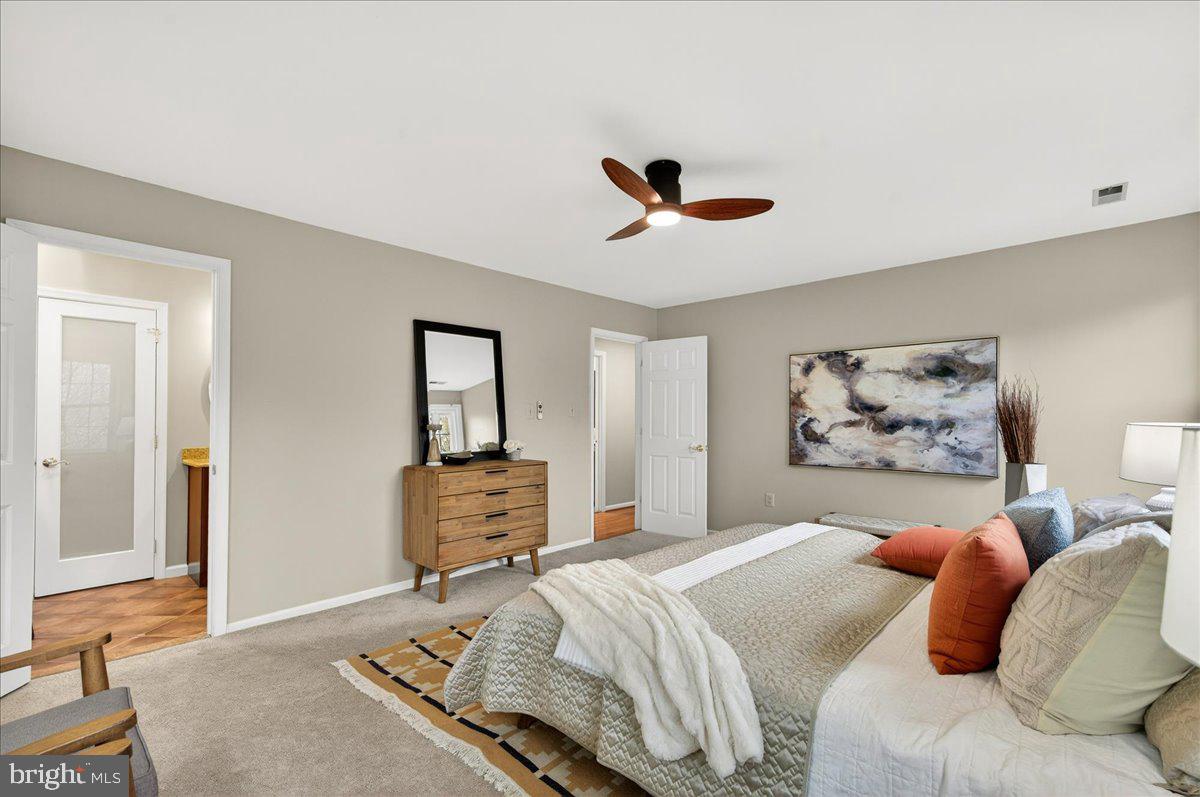 7723 Silver Sage Court Springfield, VA 22153 - Photo 36 of 63 a bedroom with a large bed and a chandelier