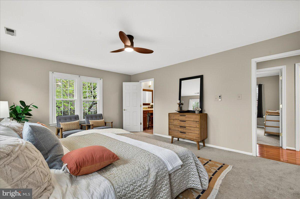 7723 Silver Sage Court Springfield, VA 22153 - Photo 38 of 63 a bedroom with a bed and wooden floor