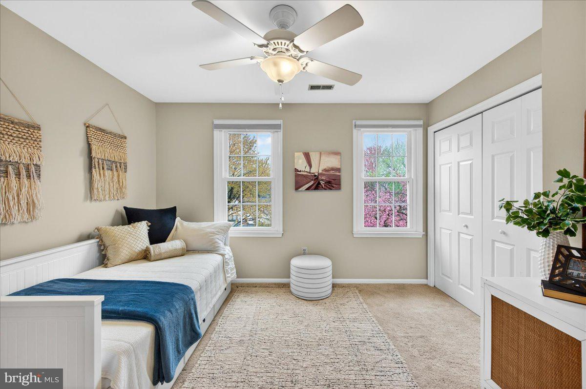 7723 Silver Sage Court Springfield, VA 22153 - Photo 39 of 63 a bedroom with a bed and a potted plant