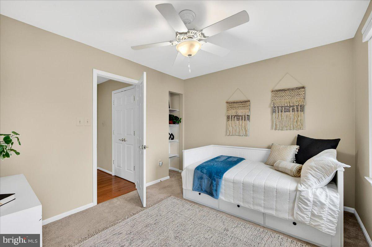 7723 Silver Sage Court Springfield, VA 22153 - Photo 40 of 63 a bedroom with a bed and a chandelier