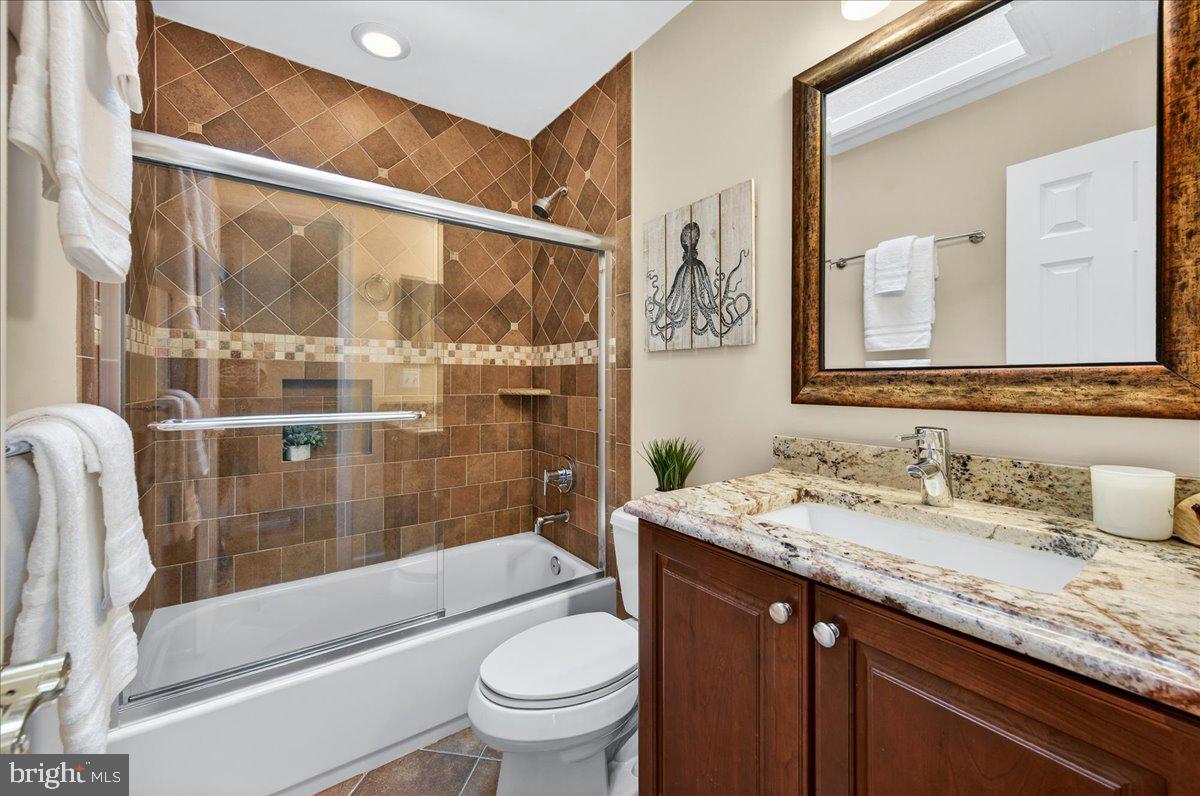 7723 Silver Sage Court Springfield, VA 22153 - Photo 43 of 63 a bathroom with a granite countertop sink toilet and shower