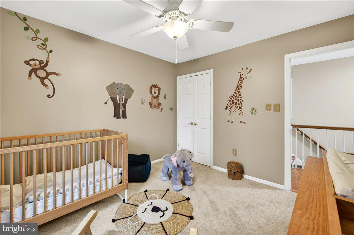 7723 Silver Sage Court Springfield, VA 22153 - Photo 44 of 63 a bedroom with a bed and white walls