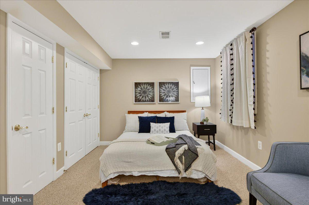 7723 Silver Sage Court Springfield, VA 22153 - Photo 49 of 63 a bedroom with a large bed and a couch