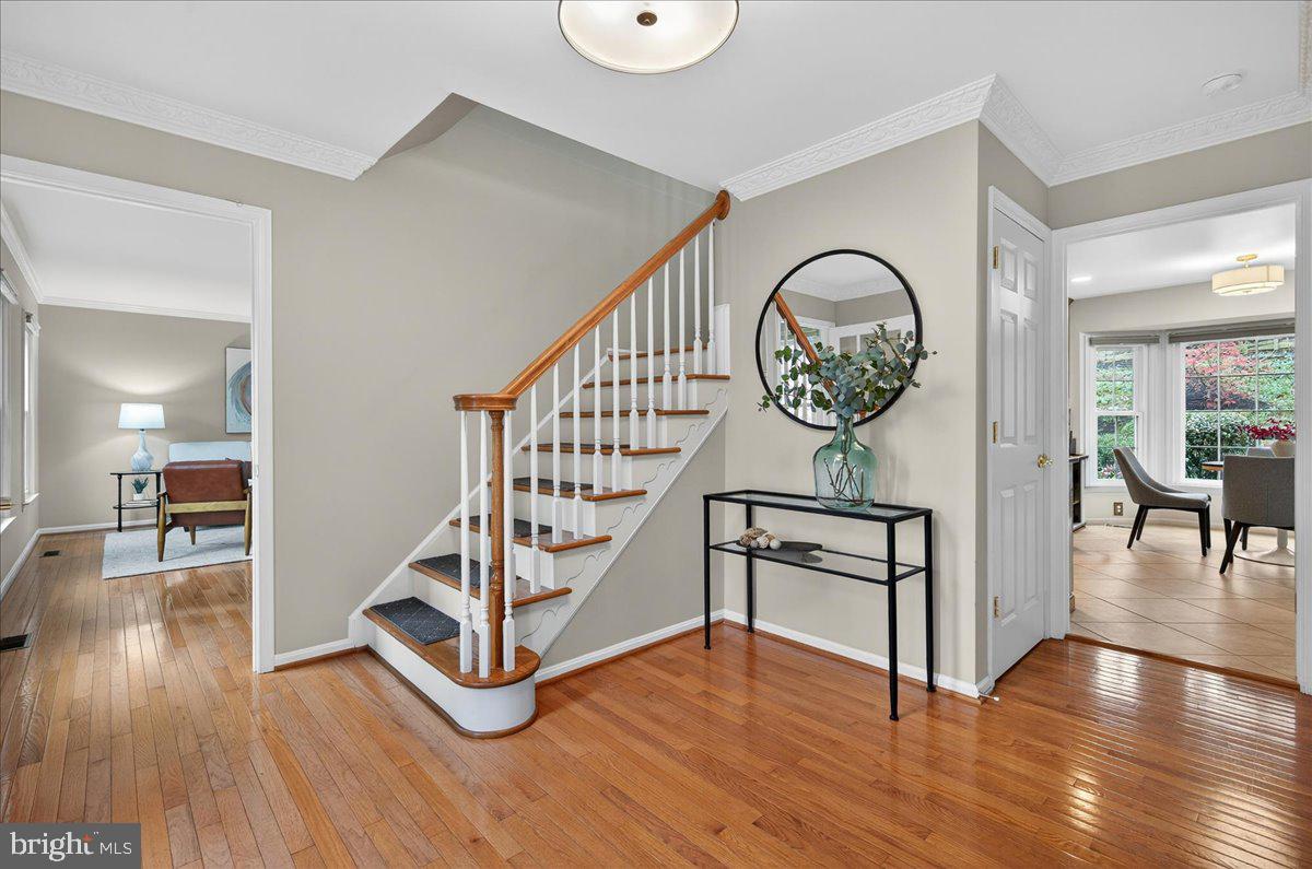 7723 Silver Sage Court Springfield, VA 22153 - Photo 6 of 63 a view of a hallway with wooden floor table and a chandelier