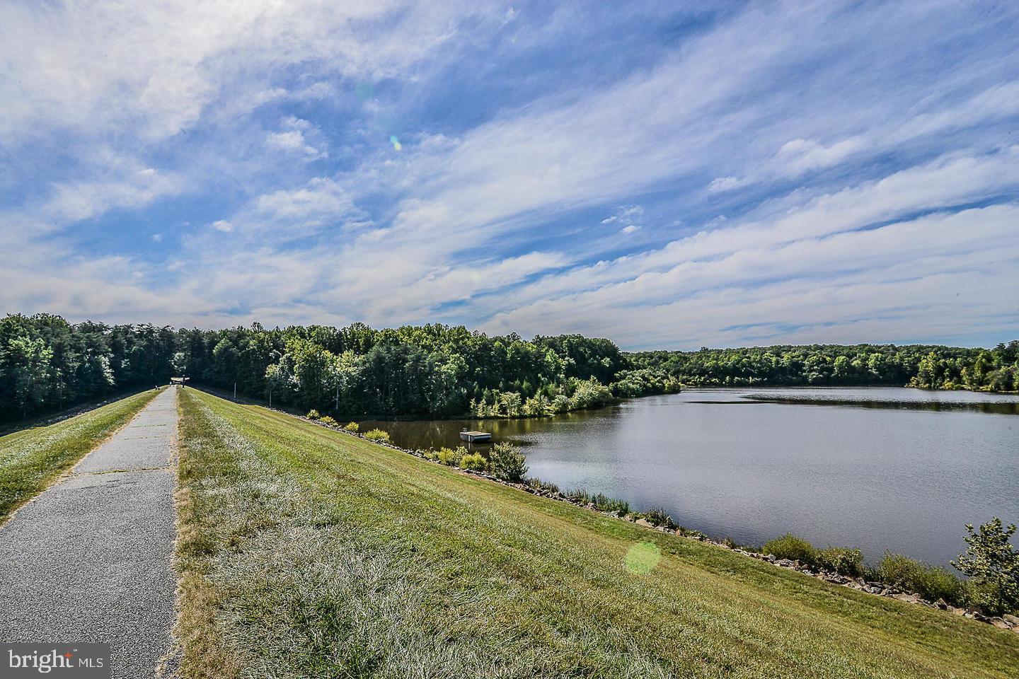7723 Silver Sage Court Springfield, VA 22153 - Photo 62 of 63 a view of a lake with a yard and large trees
