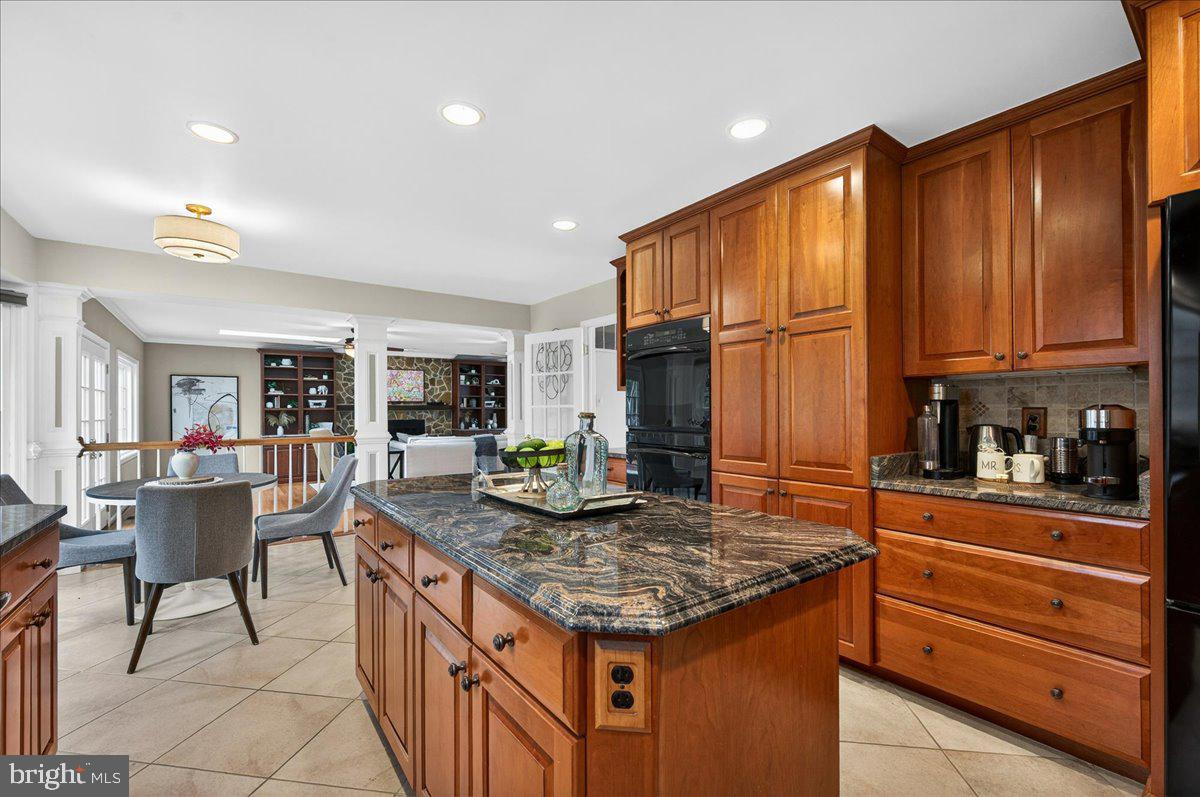 7723 Silver Sage Court Springfield, VA 22153 - Photo 8 of 63 a kitchen with granite countertop kitchen island stainless steel appliances a stove a sink a counter top space and living room view
