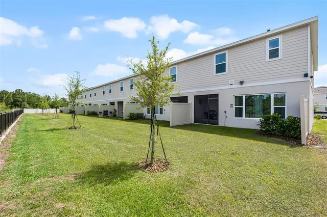 a backyard of a house with table and chairs