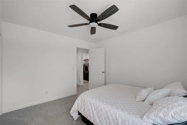 a bedroom with a bed and a ceiling fan