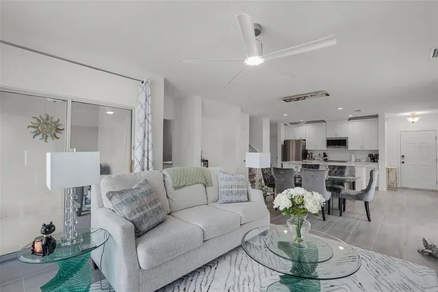 a living room with furniture kitchen view and a table