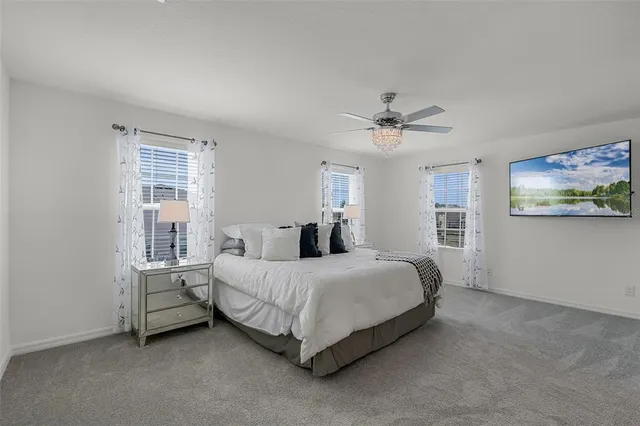 a spacious bedroom with a bed and window