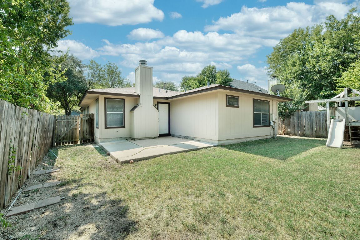 1304 Garden Path Cove Round Rock, TX 78664 - Photo 12 of 14 Back of property featuring a patio, a chimney, and a fenced backyard