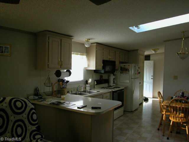 1103 Falkenberry Ridge Road King, NC 27021 - Photo 3 of 9 Other. Kitchen & Dining Area (w/skylight over table)