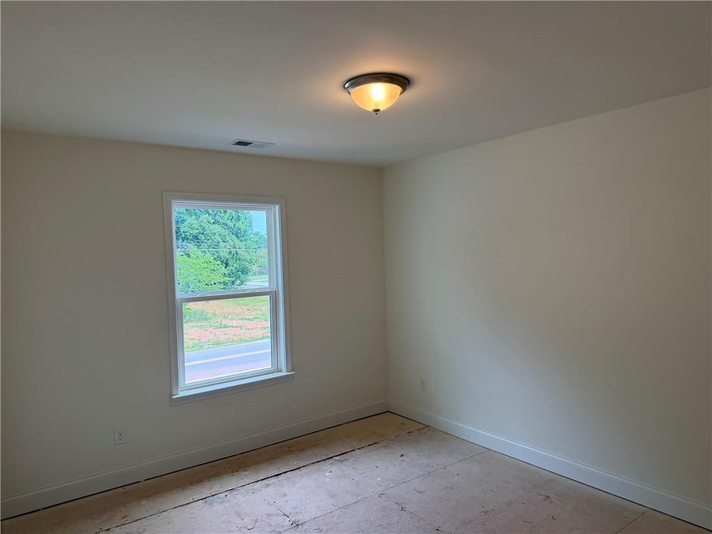 41 Woodland Road Covington, GA 30016 - Photo 13 of 46 an empty room with a window