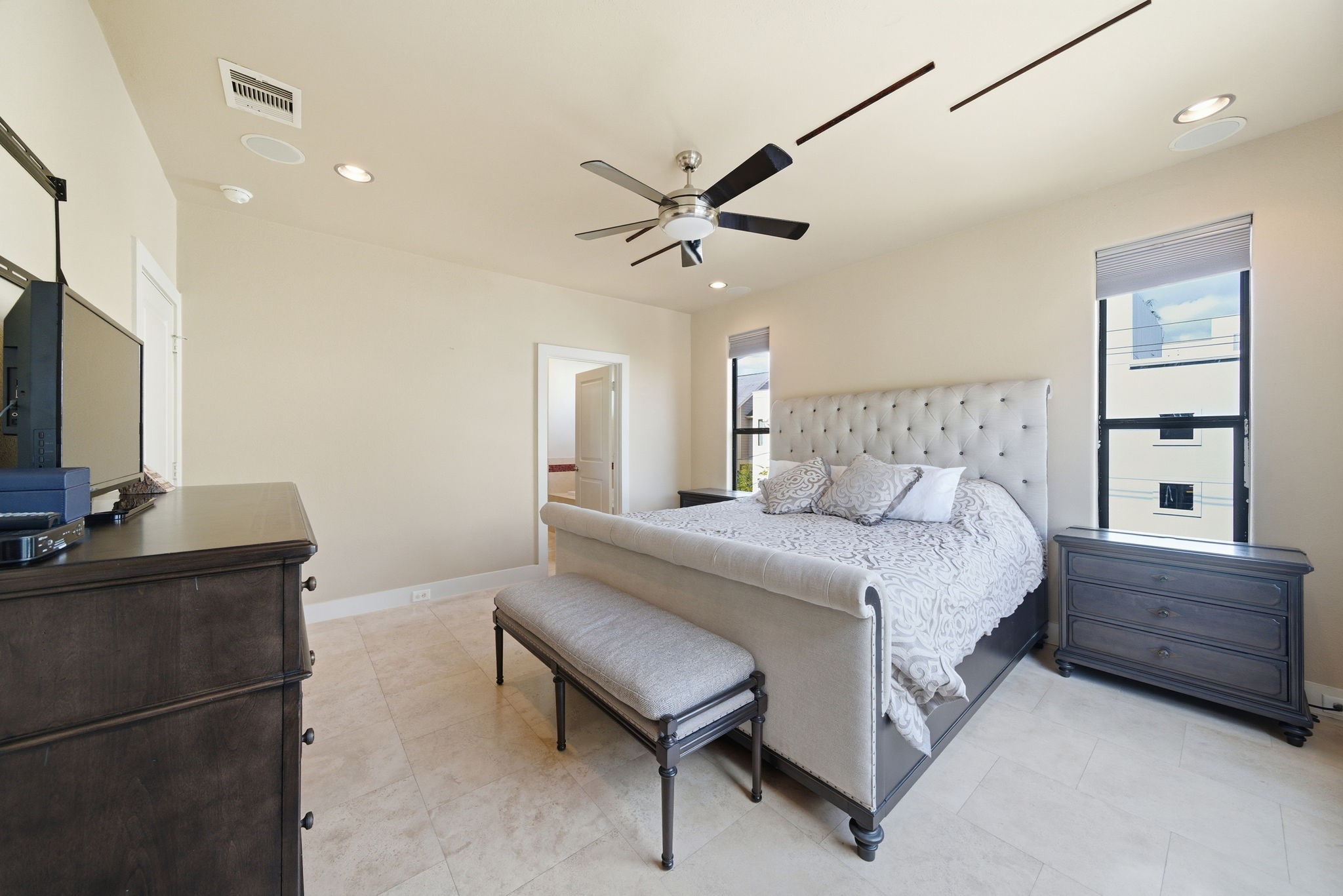 4129 Dickson Street Houston, TX 77007 - Photo 19 of 36 a bedroom with a bed furniture and a flat tv screen