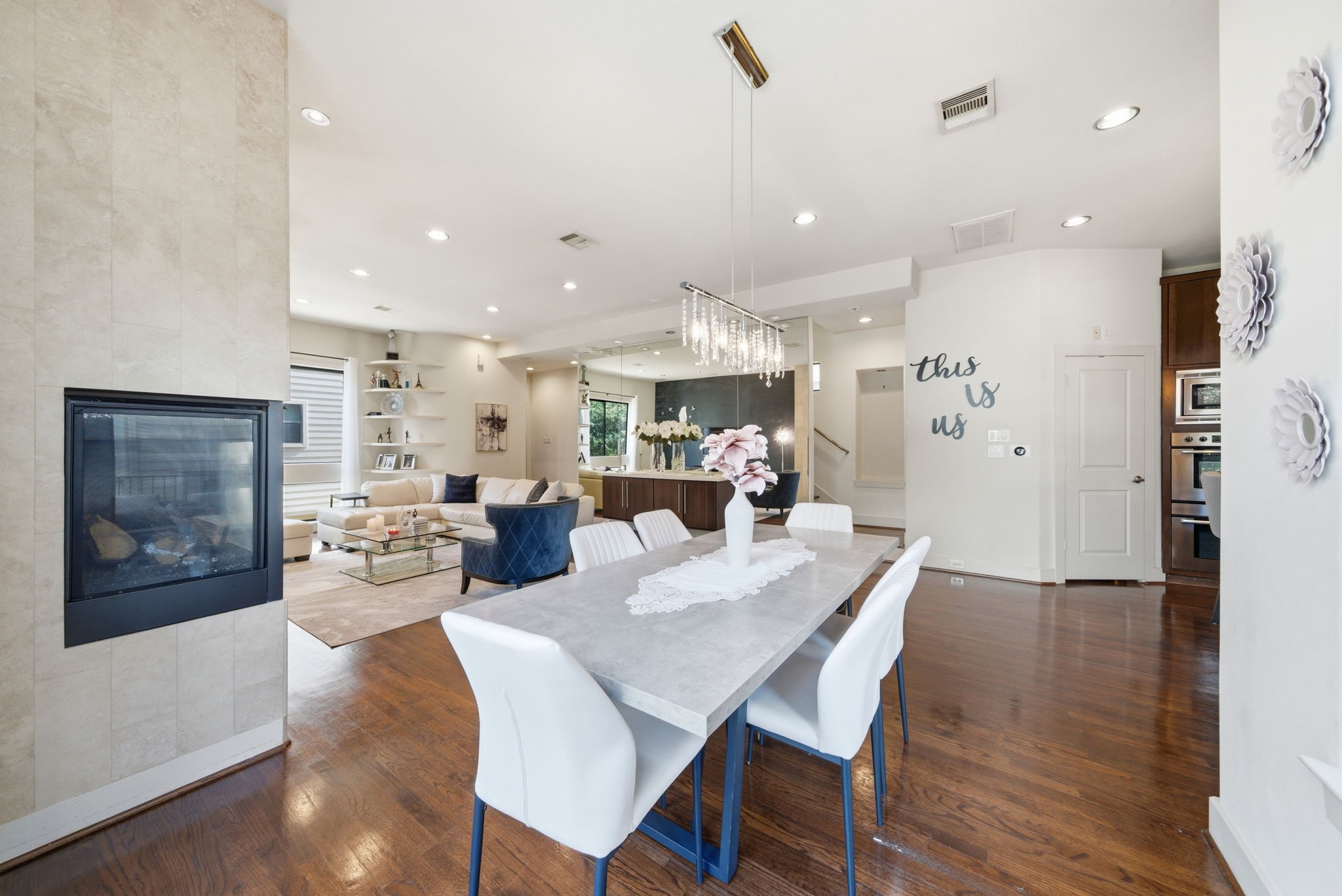 4129 Dickson Street Houston, TX 77007 - Photo 10 of 36 a view of a dining room and livingroom with furniture wooden floor a rug a fireplace