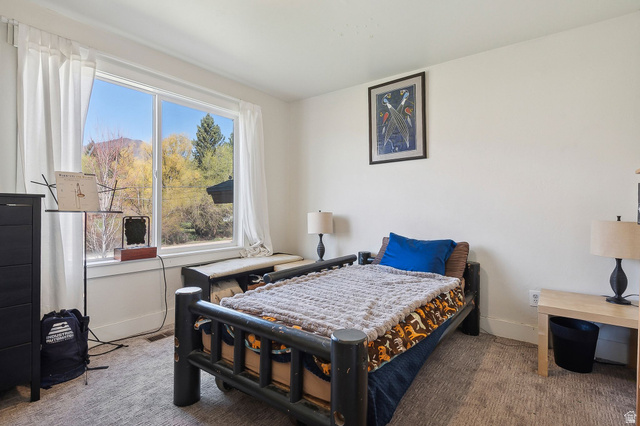 550 Pine Canyon Road Midway, UT 84049 - Photo 19 of 44 Bedroom featuring a large window with white curtains, offering a scenic outdoor landscape