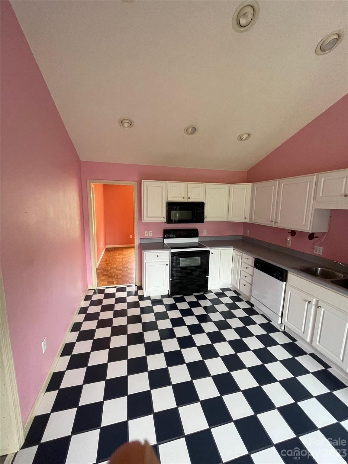 4 Grace Anna Lane Alexander, NC 28701 - Photo 20 of 38 a kitchen with a checkered floor and white cabinets