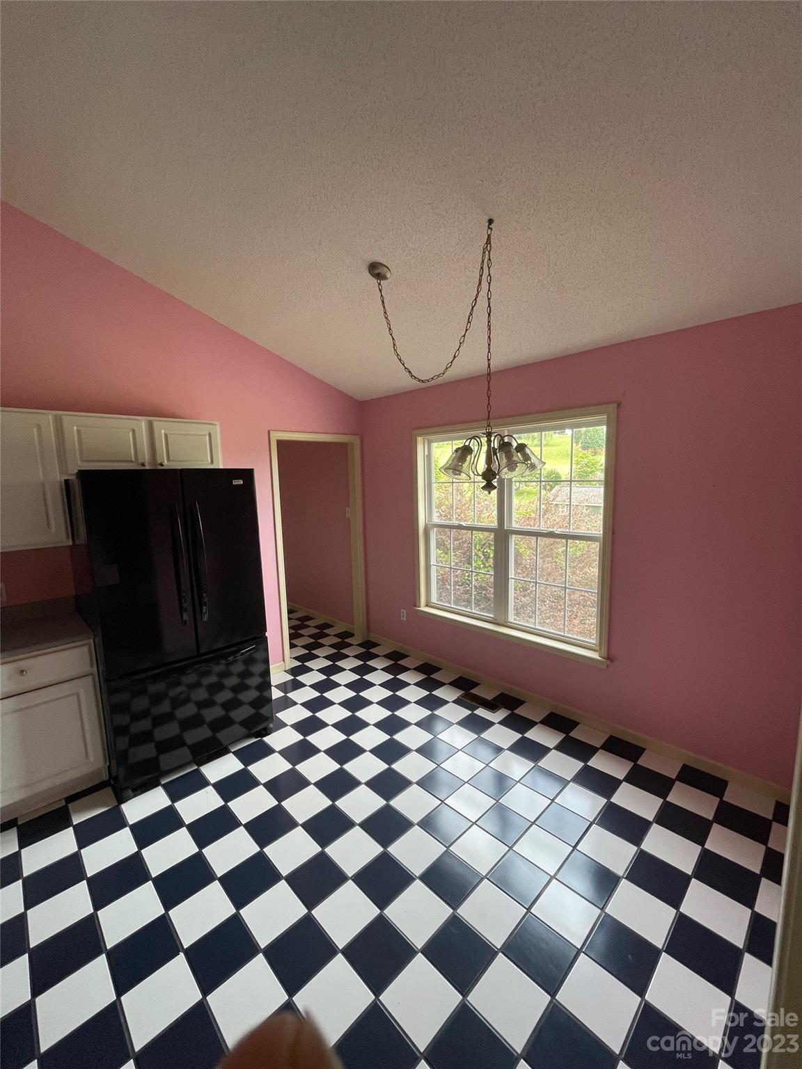 4 Grace Anna Lane Alexander, NC 28701 - Photo 22 of 38 a room with a black white checkered floor with a gaming machine and a chair