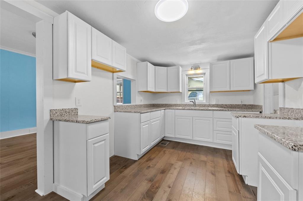242 Union Street Dickerson Run, PA 15430 - Photo 5 of 17 a kitchen with granite countertop white cabinets and white appliances