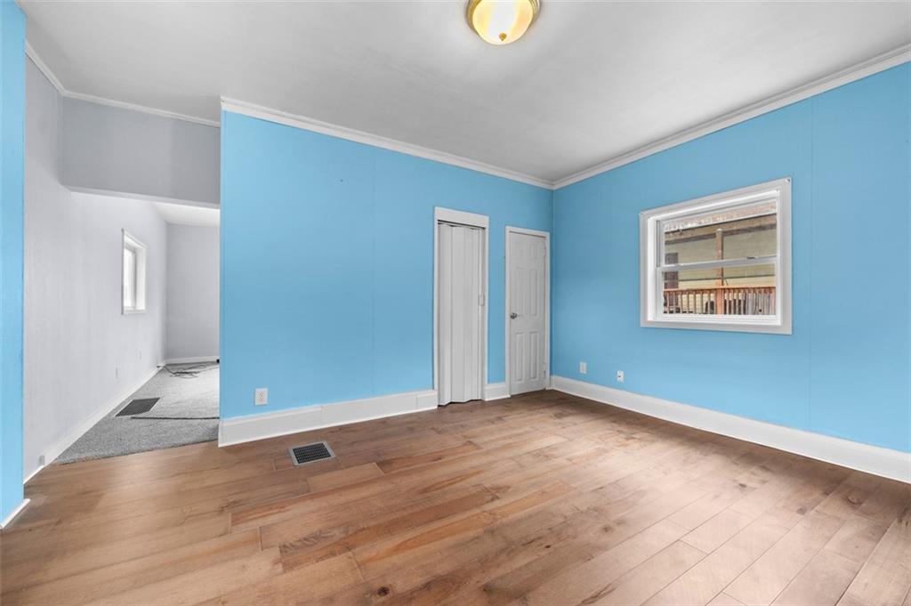 242 Union Street Dickerson Run, PA 15430 - Photo 8 of 17 an empty room with wooden floor and windows