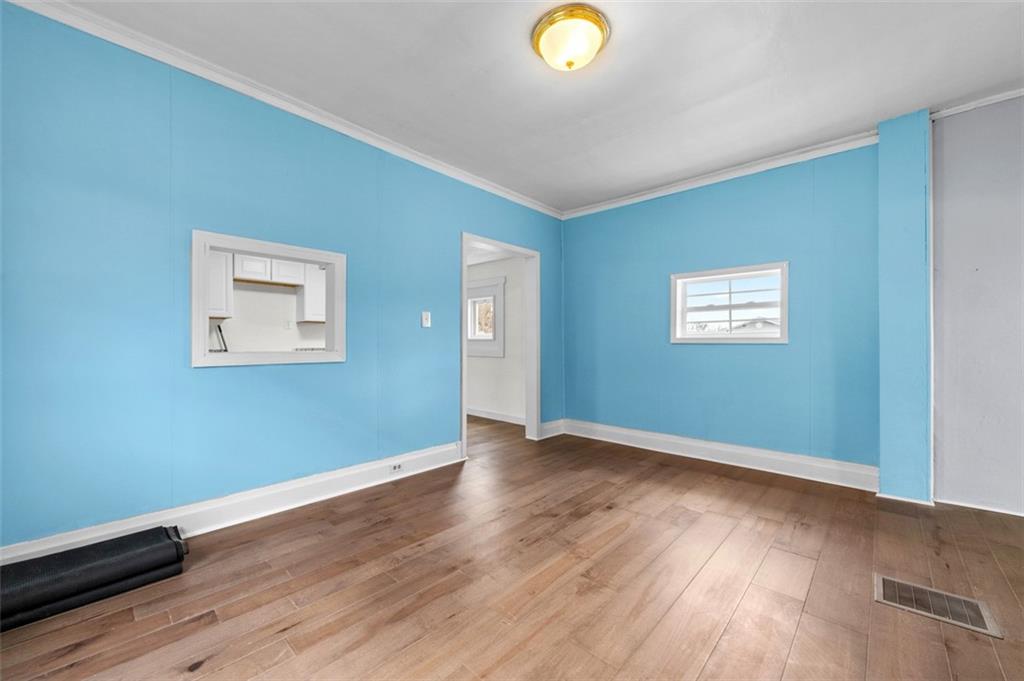 242 Union Street Dickerson Run, PA 15430 - Photo 9 of 17 a view of an empty room with wooden floor and a window