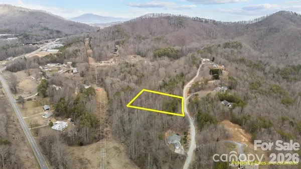 a aerial view of a house with a mountain