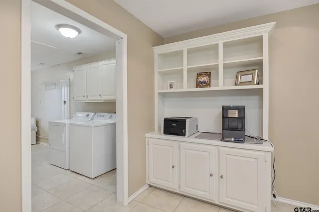 a utility room with multiple dryer and washer
