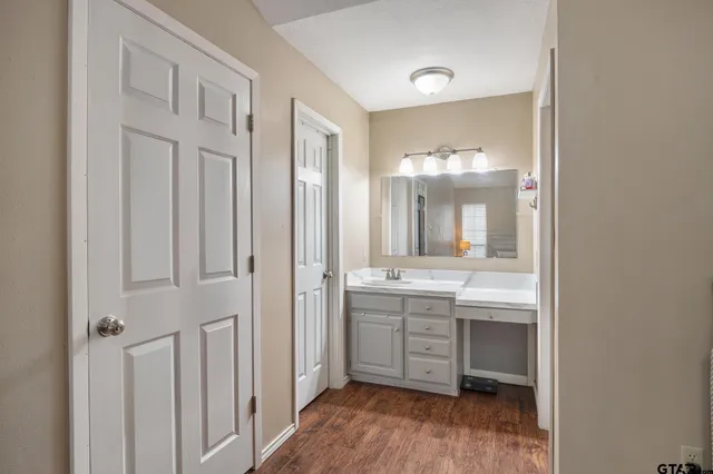 a bathroom with a double vanity sink and mirror with shower