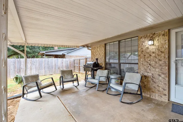 a balcony with chairs and outdoor seating