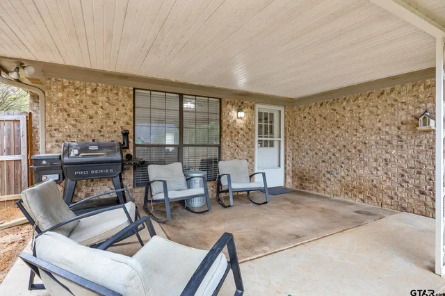 a dining room with furniture and a floor to ceiling window