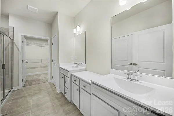 a bathroom with double sink and a mirror