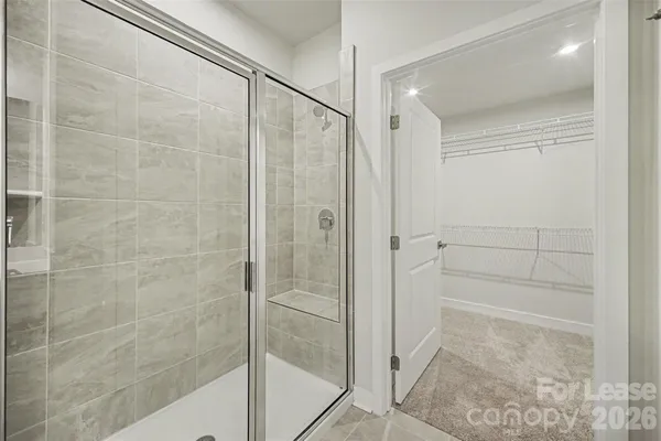 a bathroom with a glass shower door