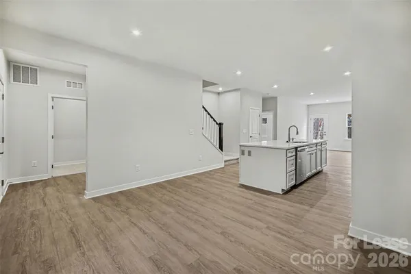 a view of kitchen with wooden floor and electronic appliances