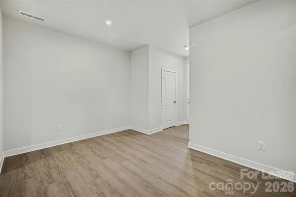 an empty room with wooden floor