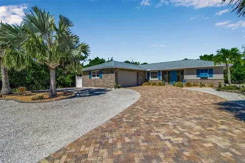 a view of a house with sitting area and swimming pool