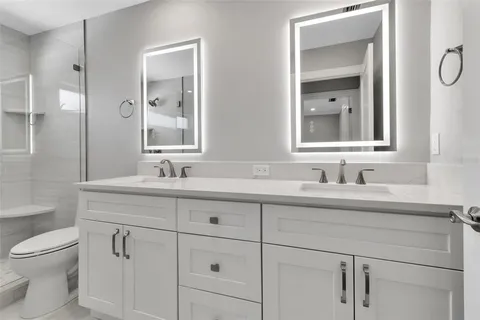 a bathroom with a sink toilet and shower