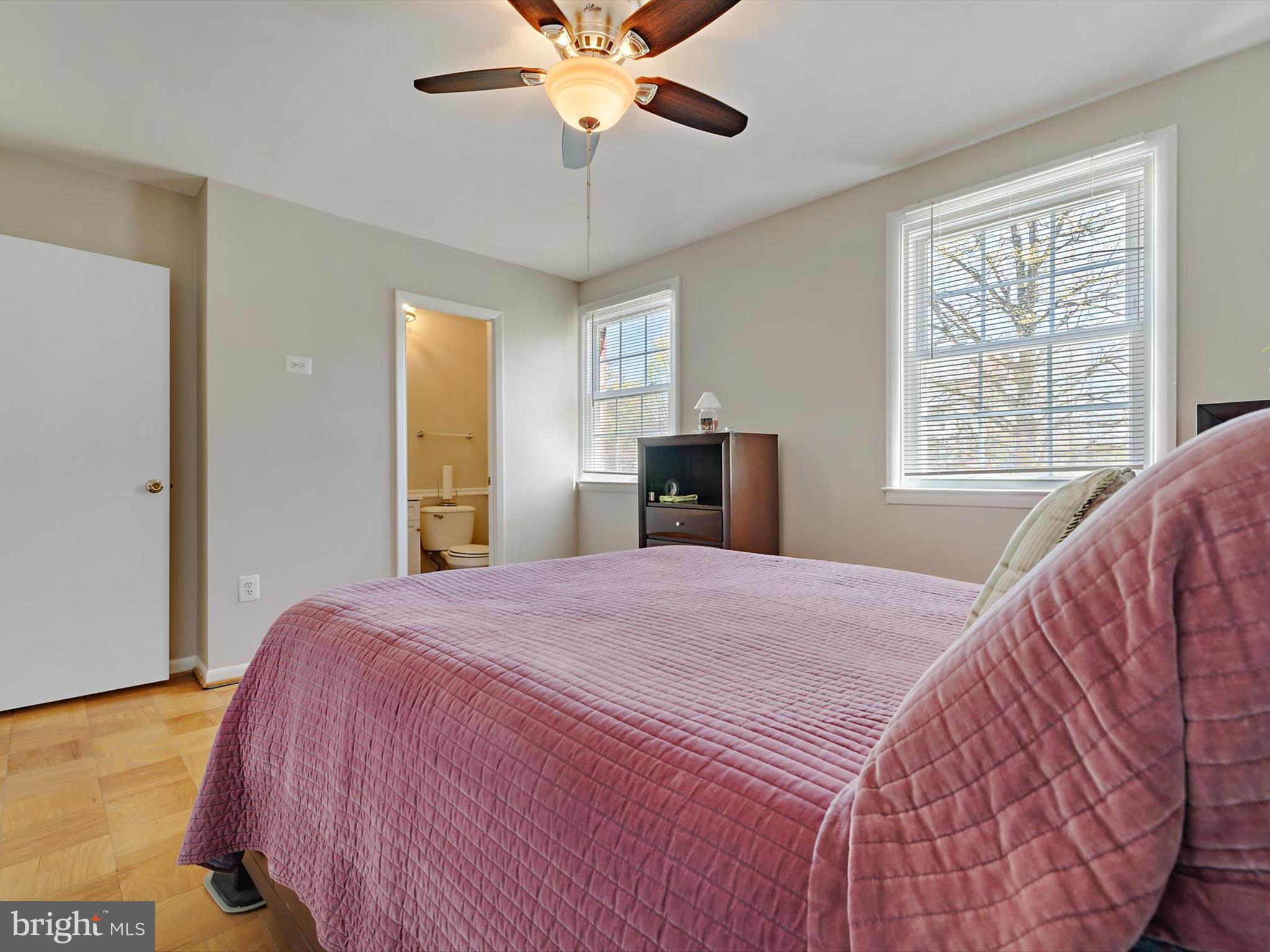 8366 Imperial Drive, Unit 2A Laurel, MD 20708 - Photo 11 of 27 a bedroom with a large bed and a chandelier
