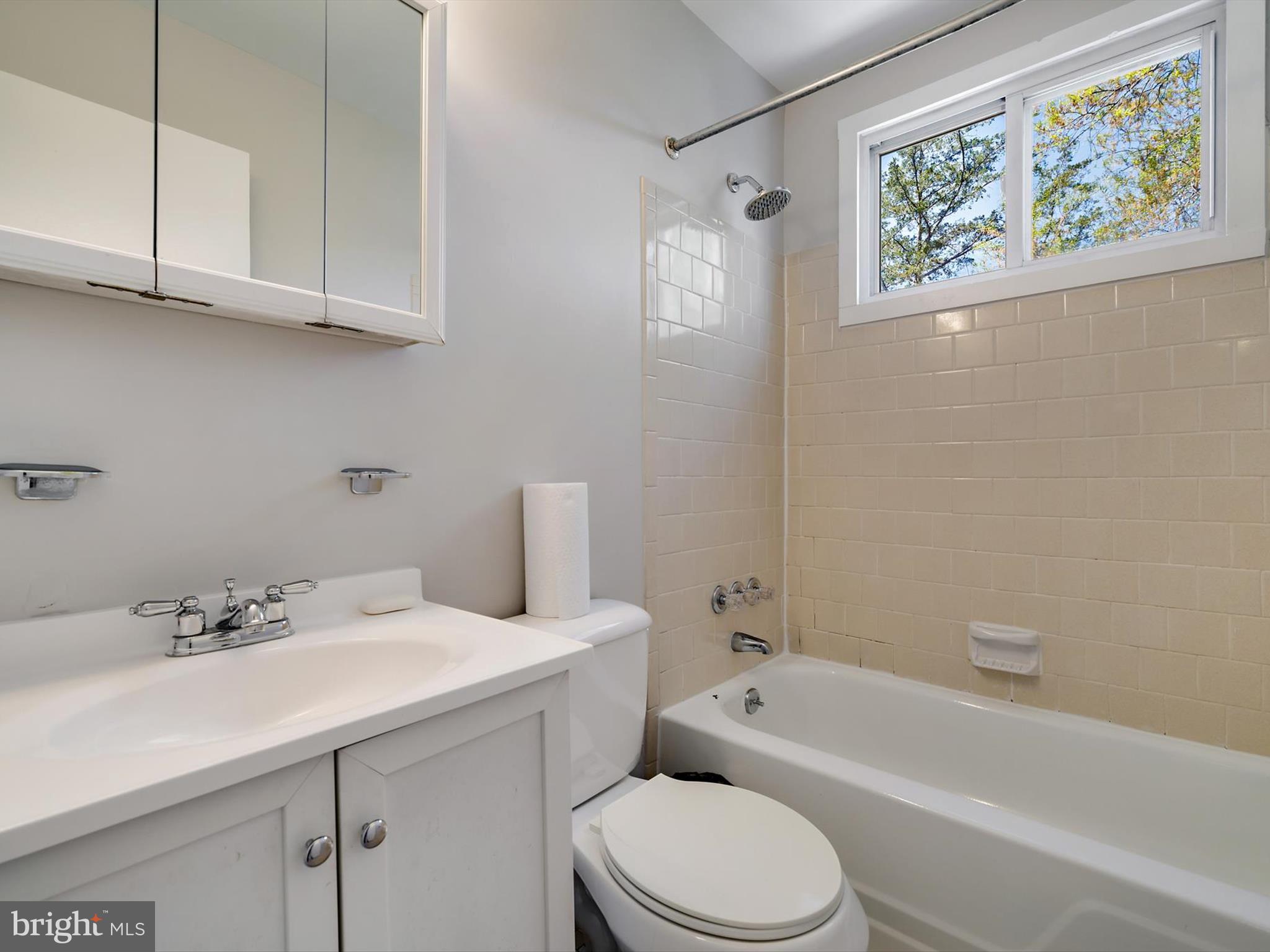 8366 Imperial Drive, Unit 2A Laurel, MD 20708 - Photo 12 of 27 a bathroom with a sink a toilet and bathtub