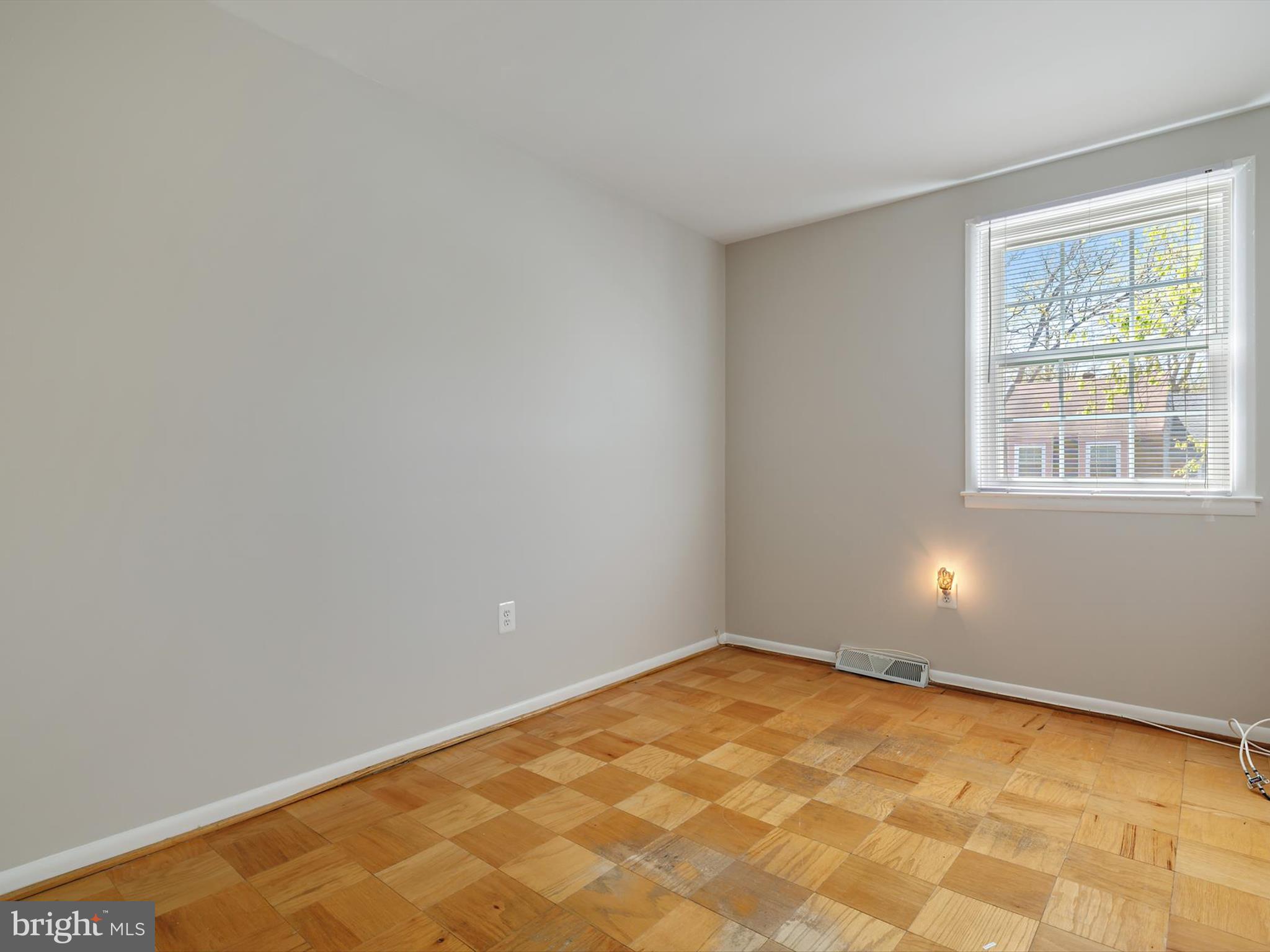 8366 Imperial Drive, Unit 2A Laurel, MD 20708 - Photo 15 of 27 wooden floor in an empty room with a window