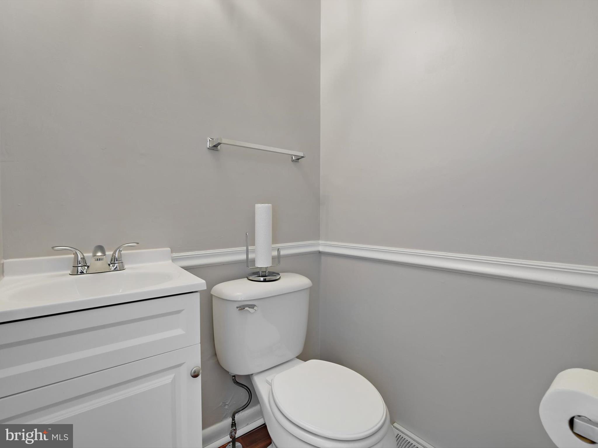 8366 Imperial Drive, Unit 2A Laurel, MD 20708 - Photo 17 of 27 a bathroom with a sink a toilet and a mirror