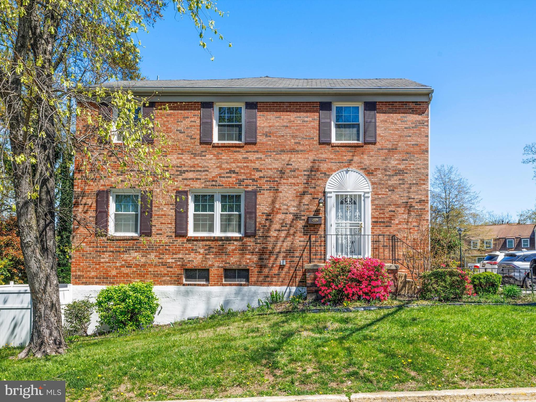8366 Imperial Drive, Unit 2A Laurel, MD 20708 - Photo 25 of 27 a front view of a house with a yard and outdoor seating