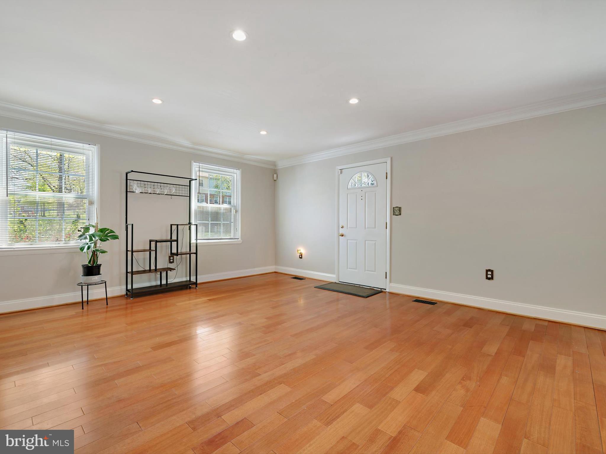 8366 Imperial Drive, Unit 2A Laurel, MD 20708 - Photo 4 of 27 a view of an empty room with wooden floor and a window