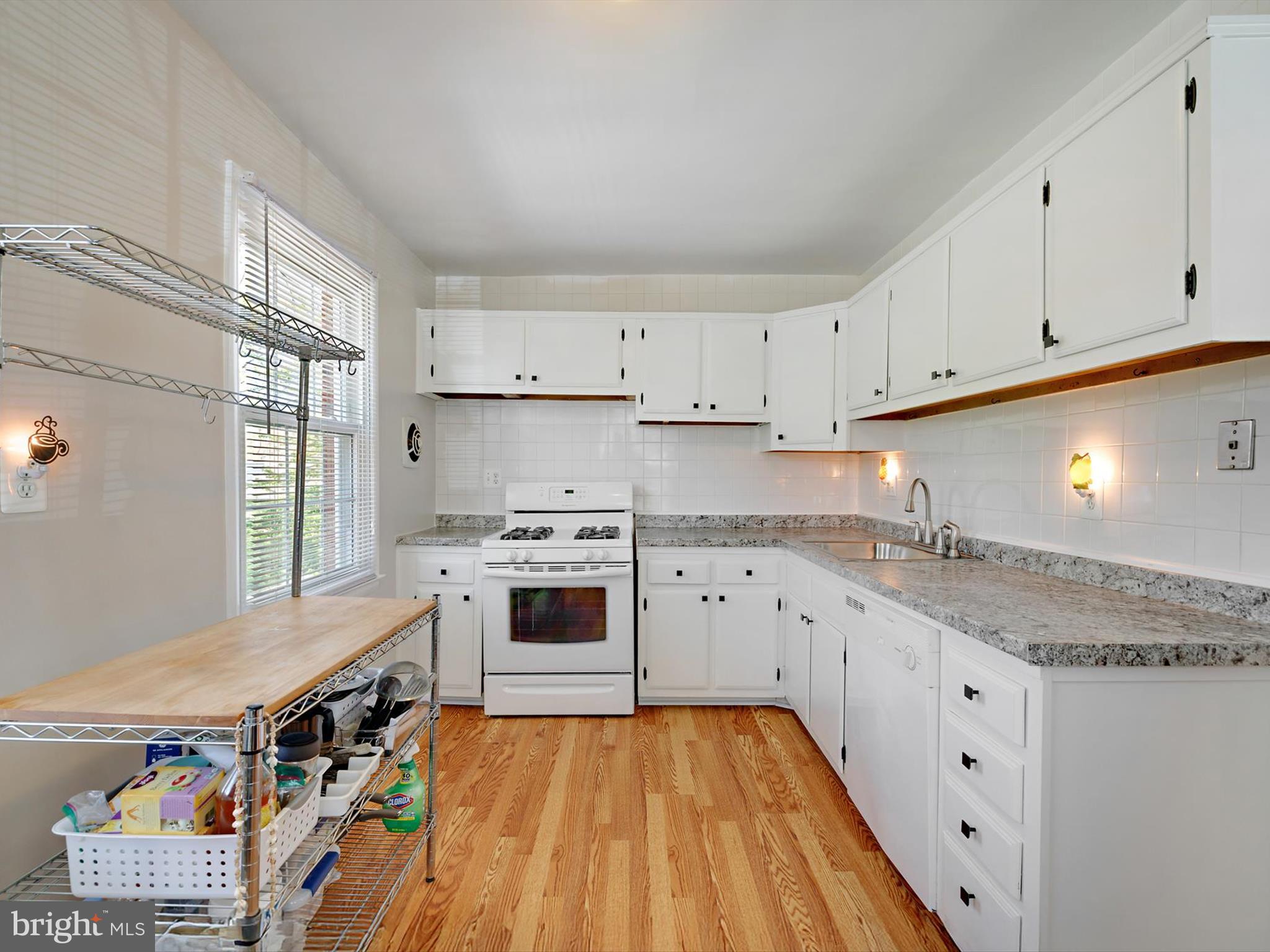 8366 Imperial Drive, Unit 2A Laurel, MD 20708 - Photo 8 of 27 a kitchen with cabinets appliances wooden floor and a window